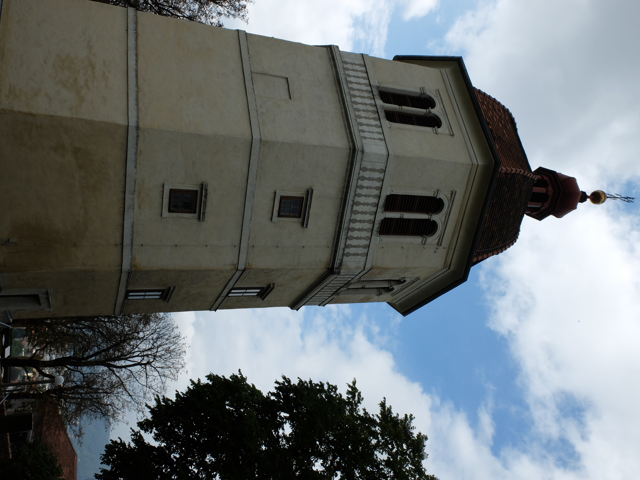 this large building has a small bell tower with many windows