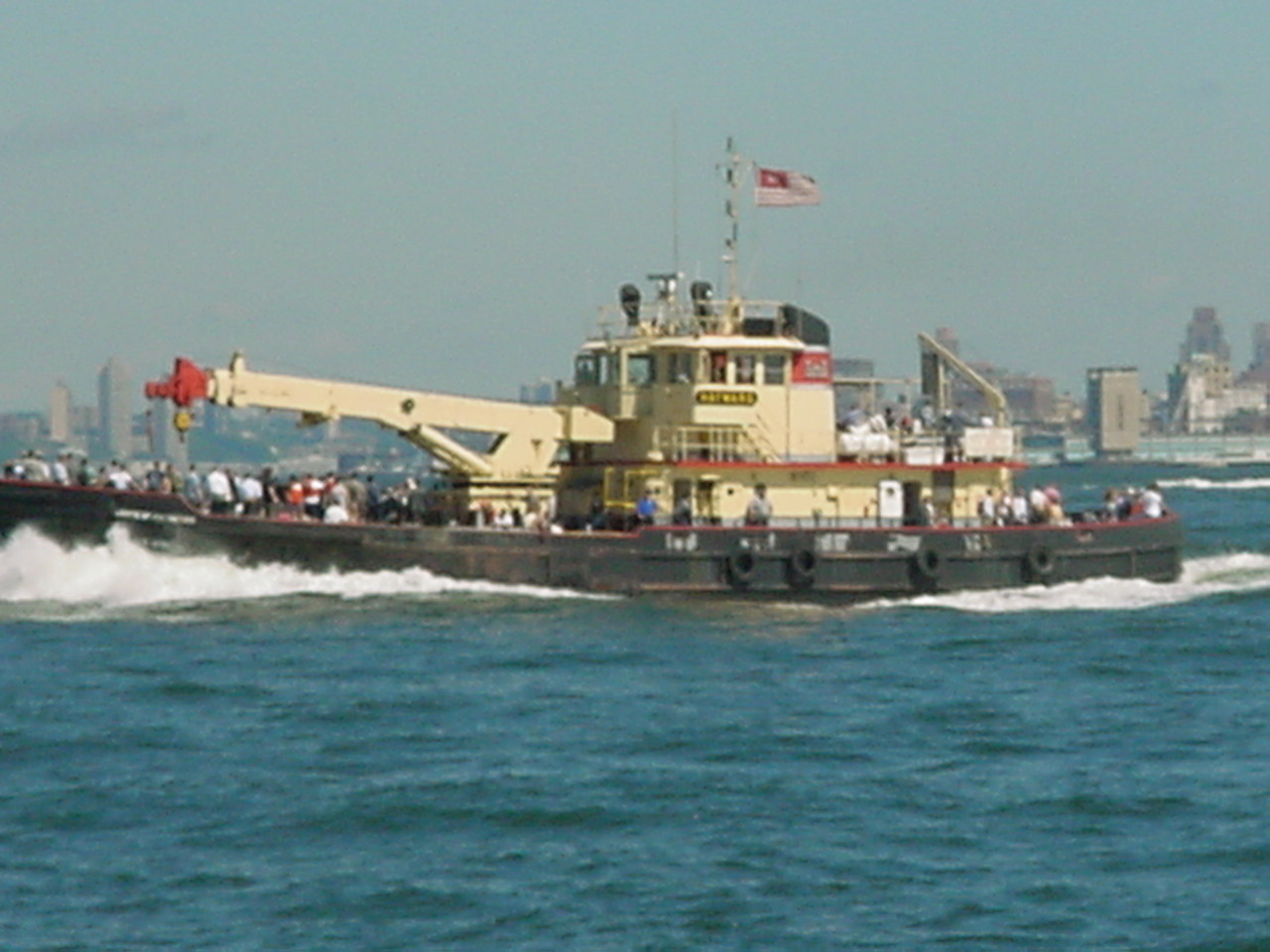 an tugboat full of people in the water