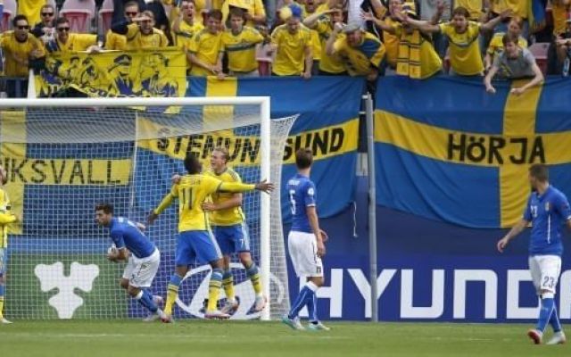 a group of soccer players standing on a field