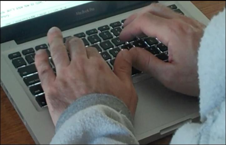 two hands on a laptop keyboard typing at a black keys