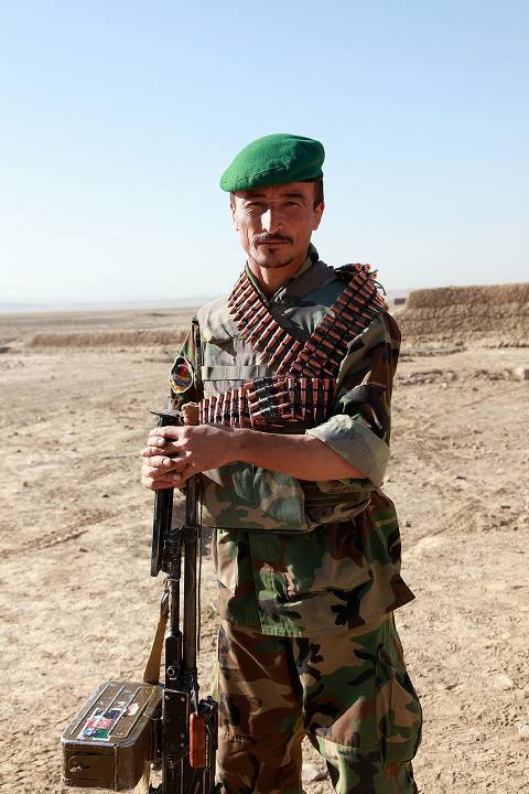 soldier with machine gun in desert plain, oman