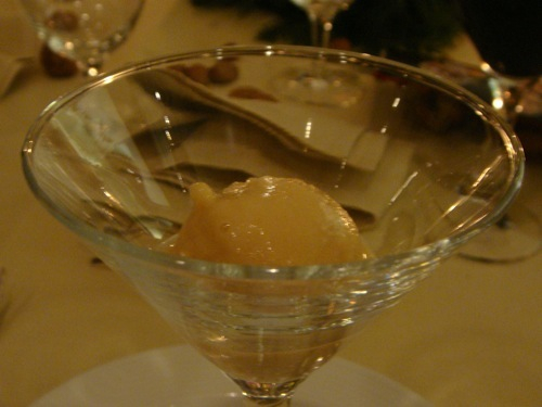 a glass is sitting on a place setting