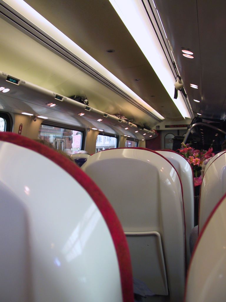 white and red seats and lights on a train
