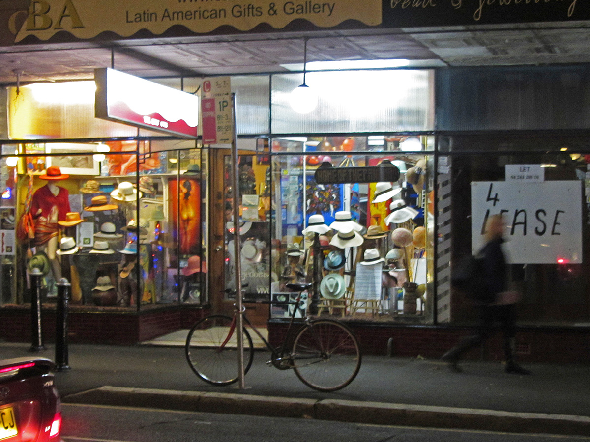 a bicycle is parked outside a store front