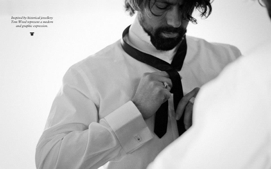 a man that is tying another mans tie