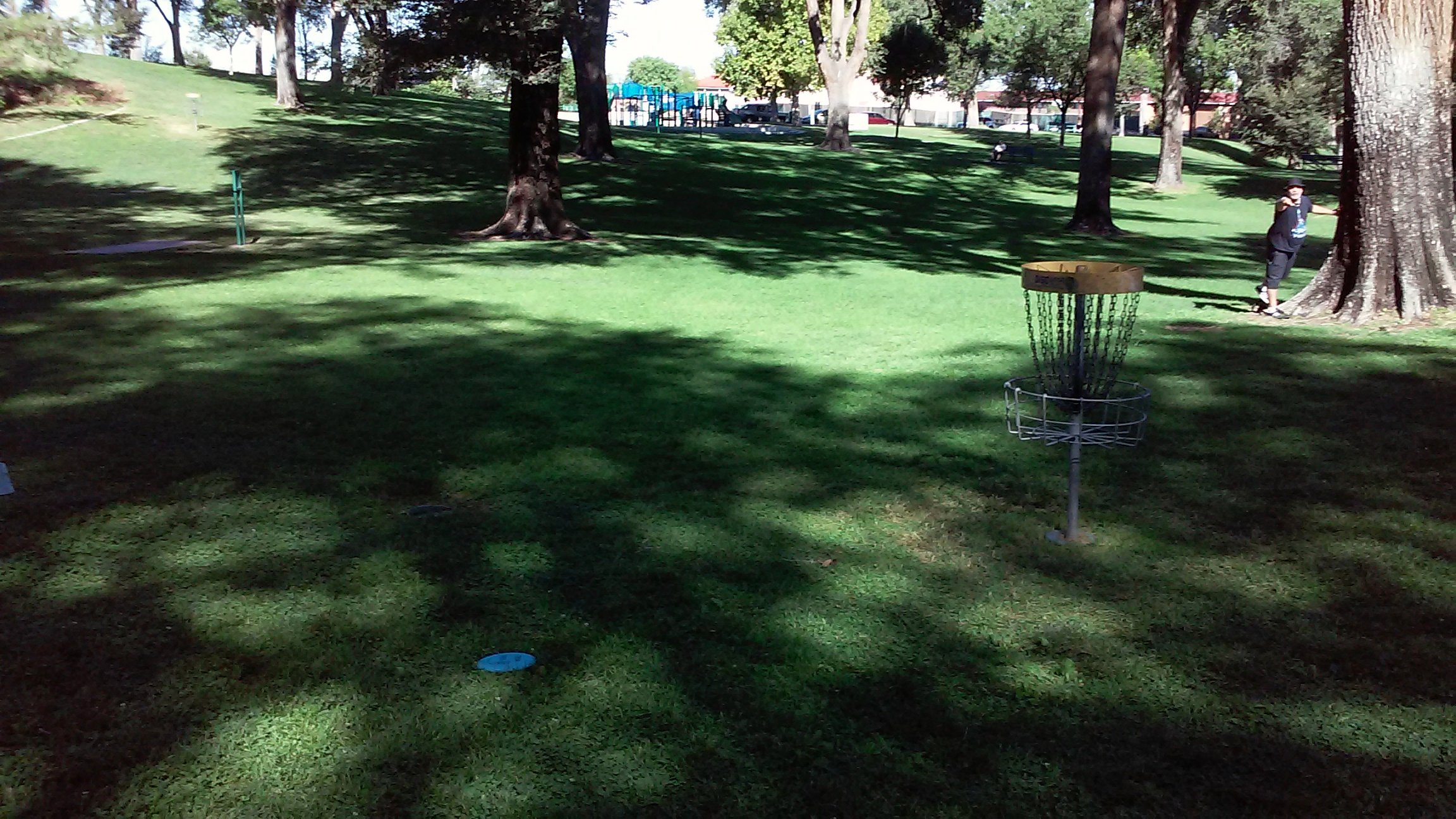 two people are on the field with a disc golf game