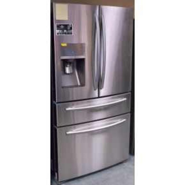 a large silver refrigerator in a kitchen