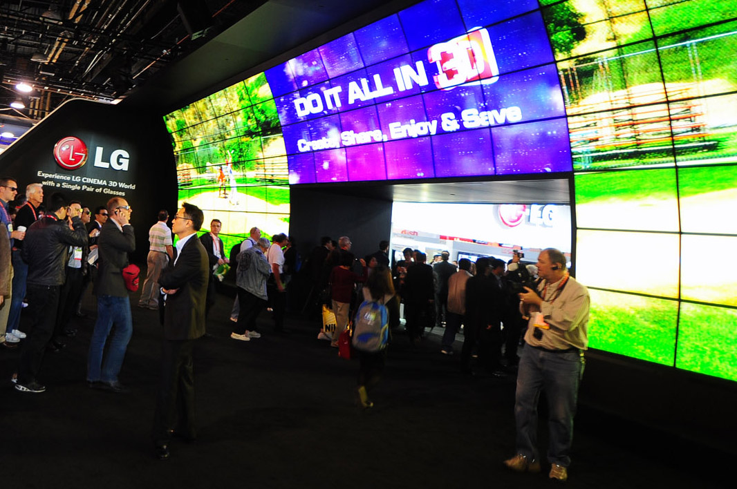 a large group of people on a carpet by a big tv screen