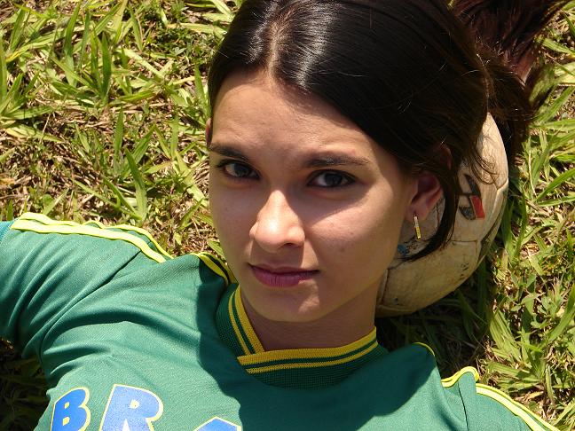 a woman is laying down next to a soccer ball
