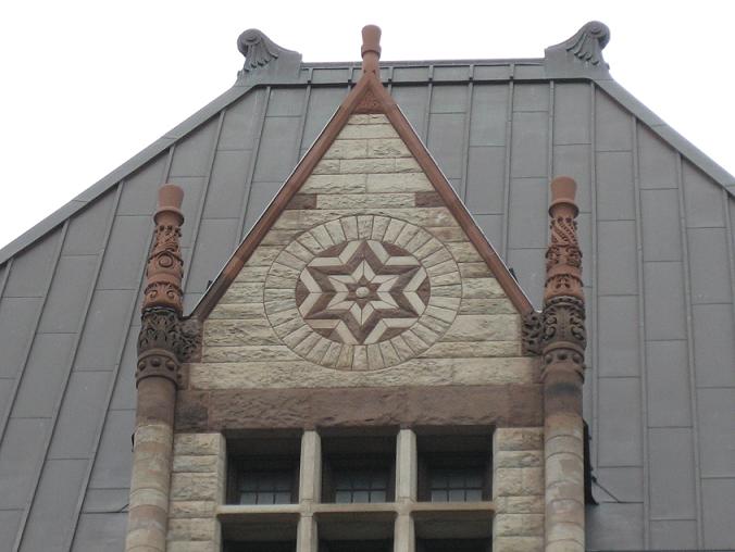 the roof of a building has a star and circle design on it
