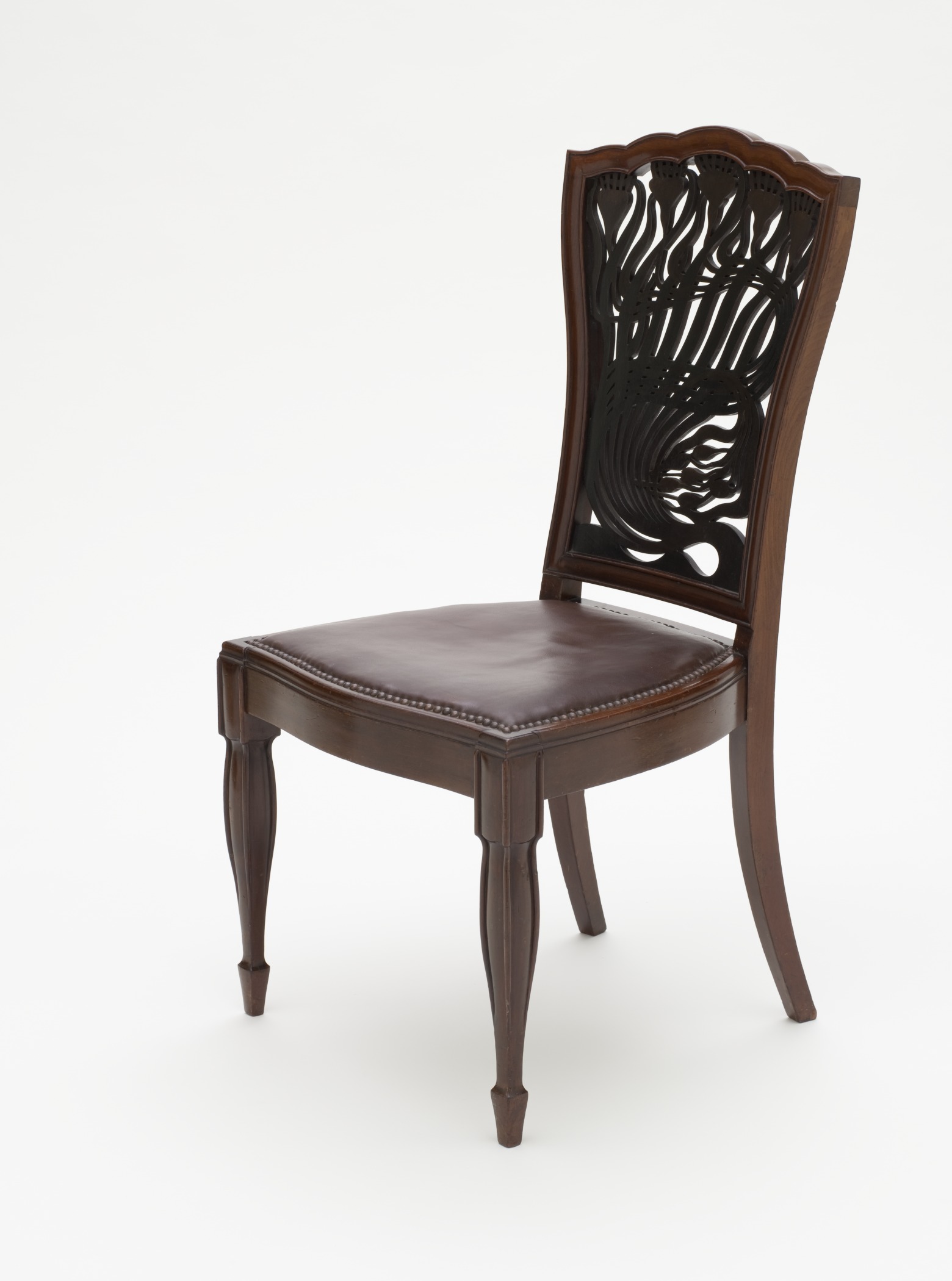 a dark colored chair with wooden legs and a leather seat