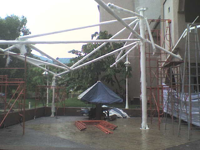 several scaffolding on the ground around an umbrella