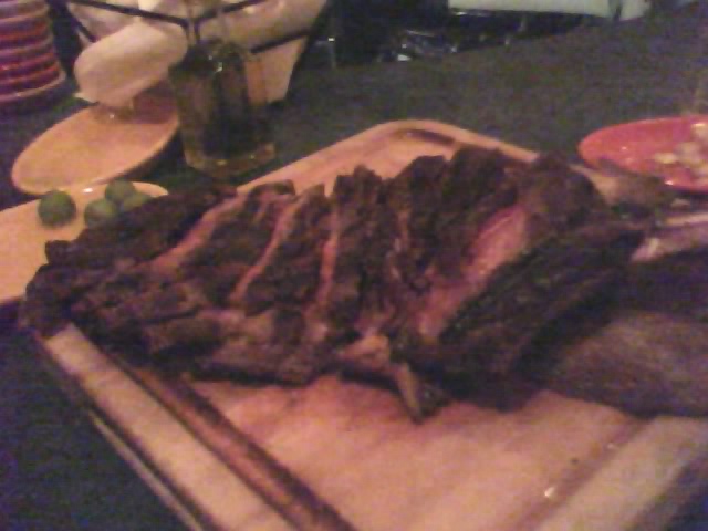 steaks are on the chopping board with the side dish beside it