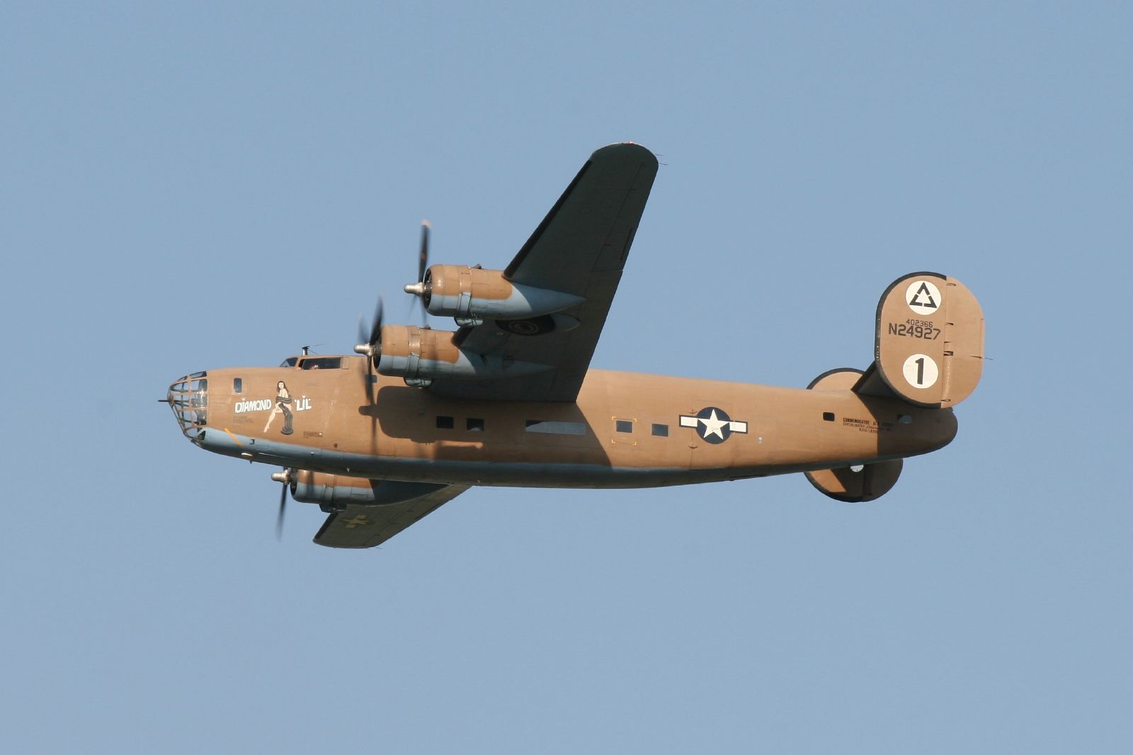 an old war plane is flying in the air