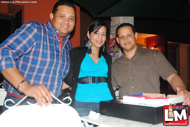 a group of people standing around a table