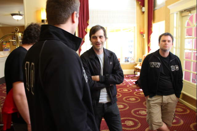 a group of men are standing in a room