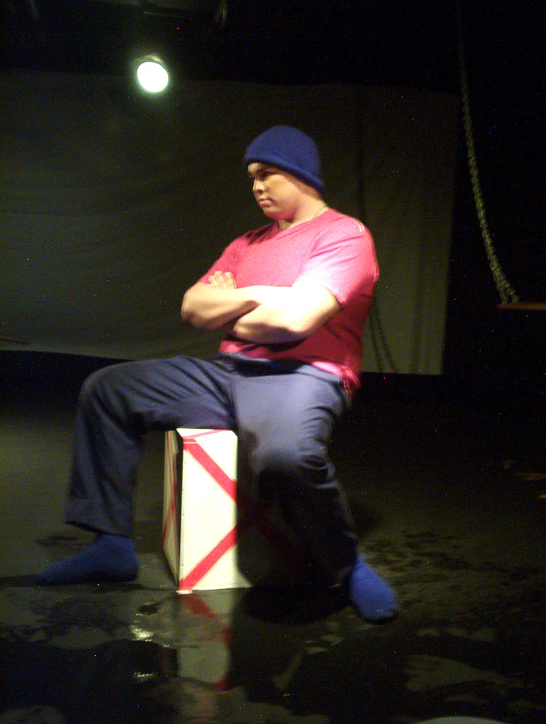 the man sits on a box in a theater