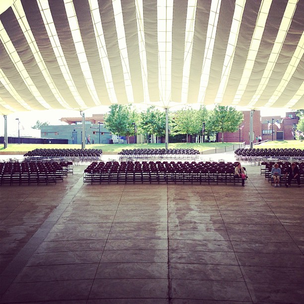 the inside of a large building with benches under it