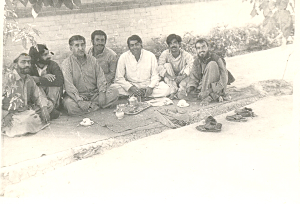 an old po of people sitting on the ground