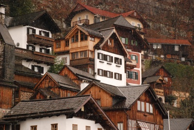 old european wooden houses are on a hill side
