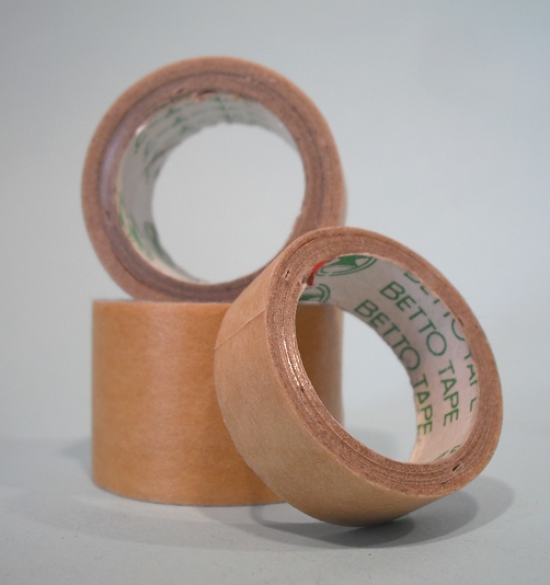 two rolls of paper tape on a plain surface