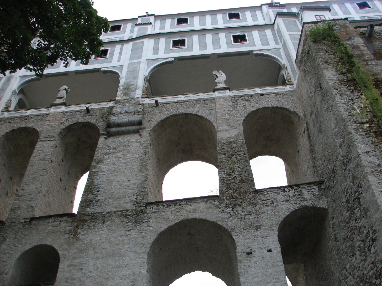 a castle built into the side of a cliff with several windows