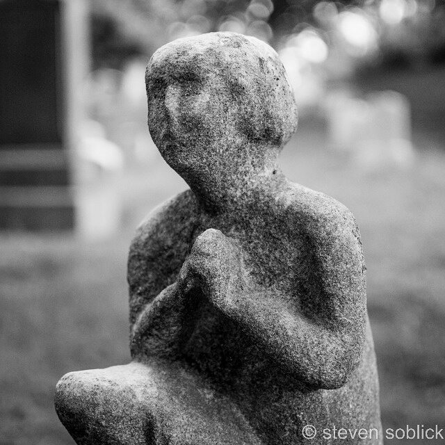 black and white po of a sculpture that looks like someones head