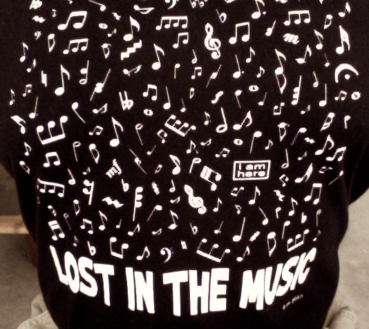 the back of the hoodie has a lot of music notes and letters all over it