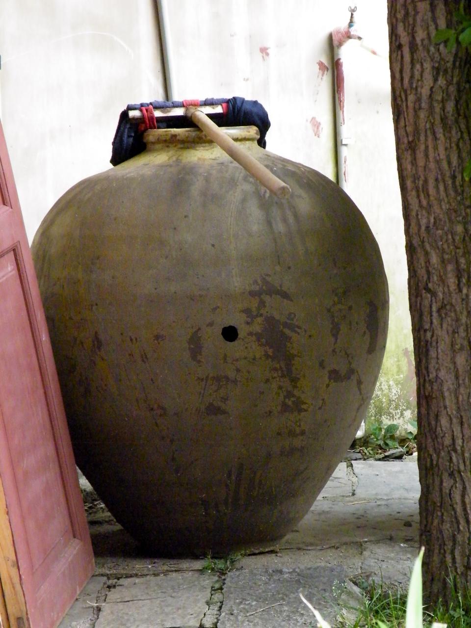 a large large piece of pottery near a tree