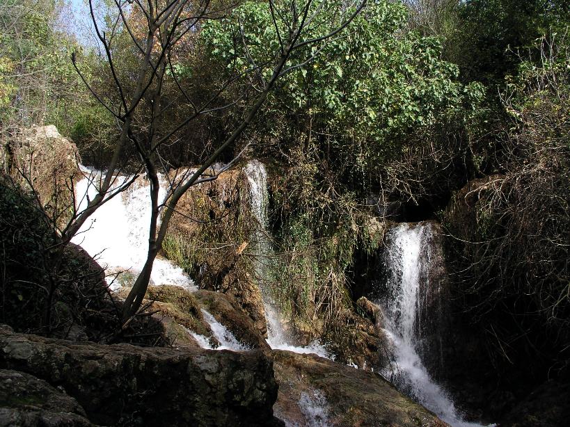 a beautiful waterfall flowing from a cliff into the lake