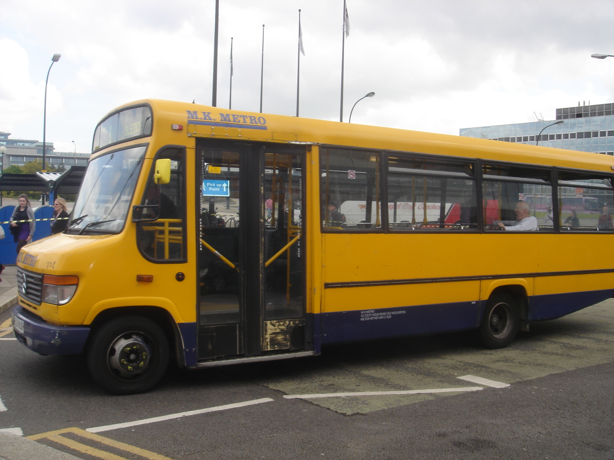 the bus is yellow with blue stripes in front