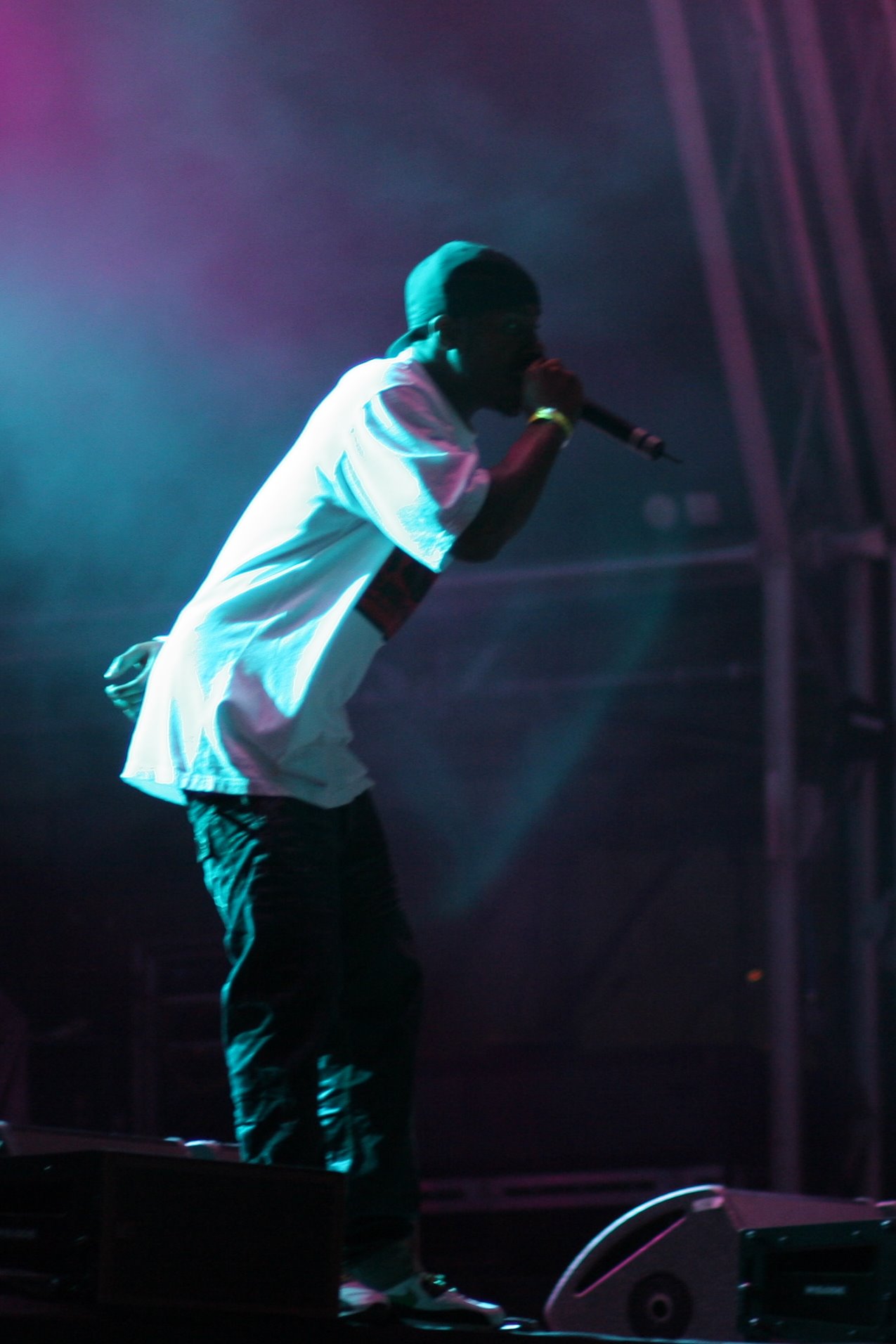 the rapper performs on stage with blue lights
