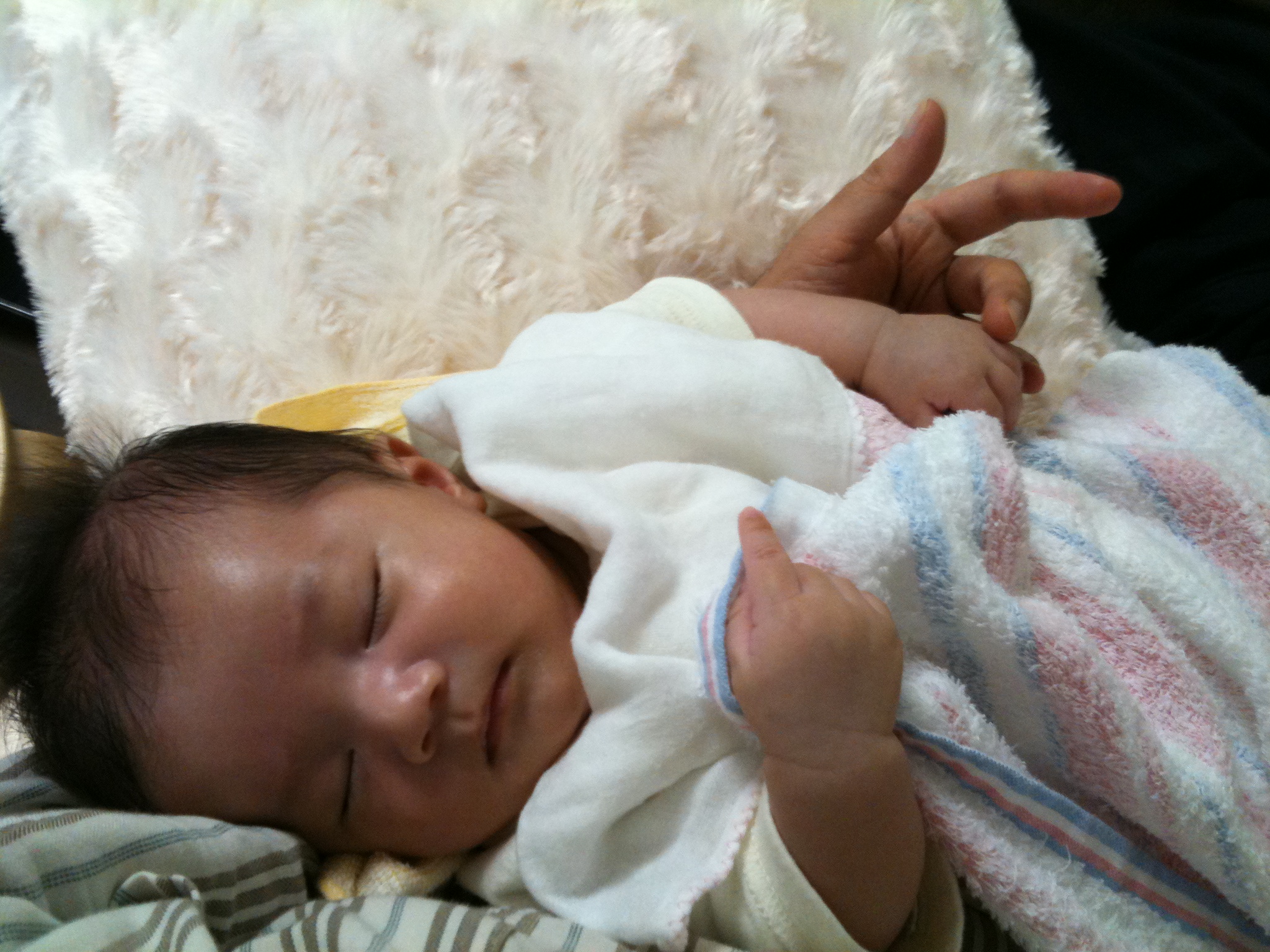 a young baby is sleeping on a chair