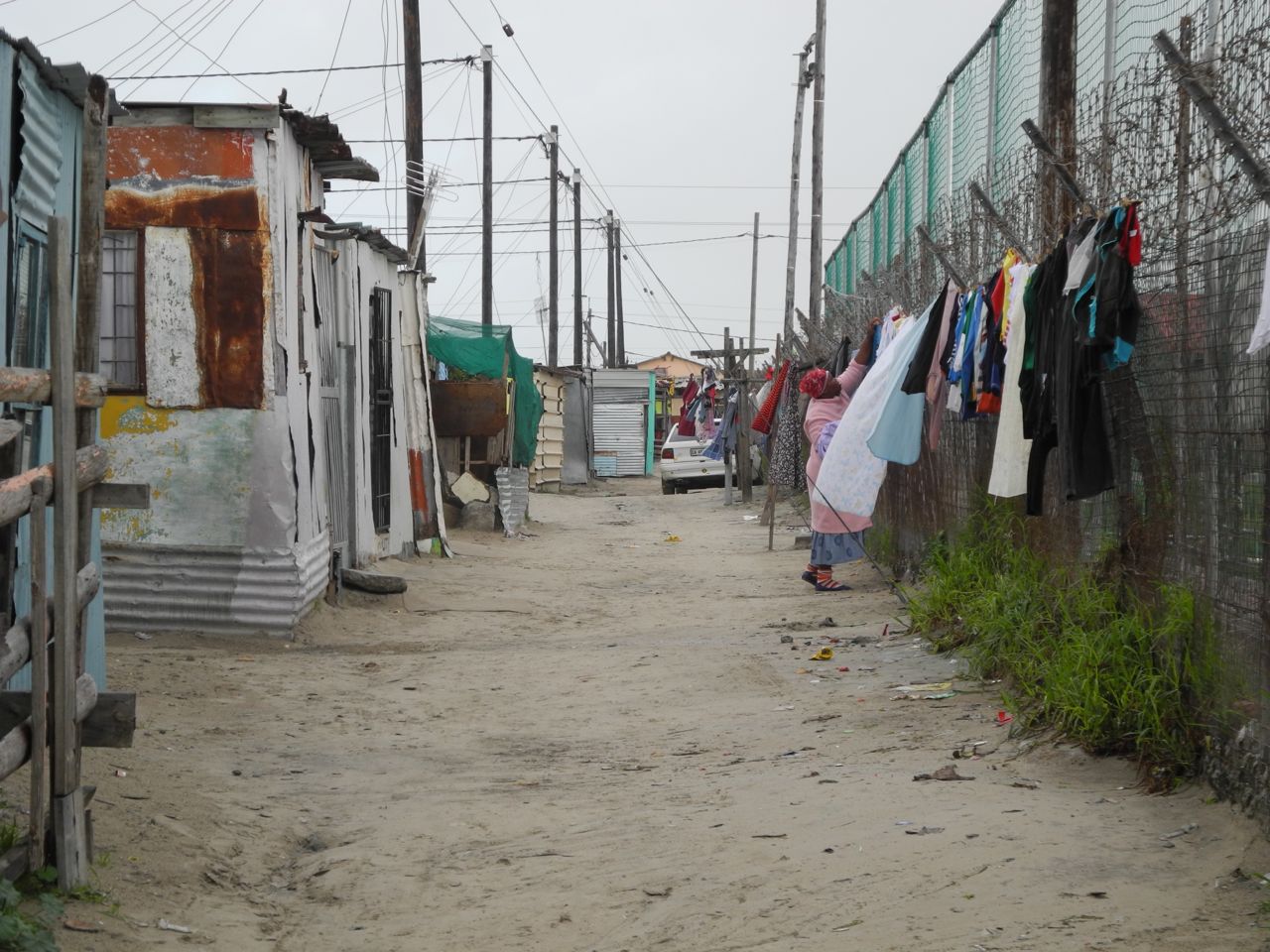 some clothes hanging on the line outside of some shacks