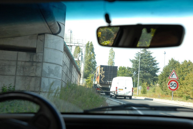 a truck drives along the side of a road