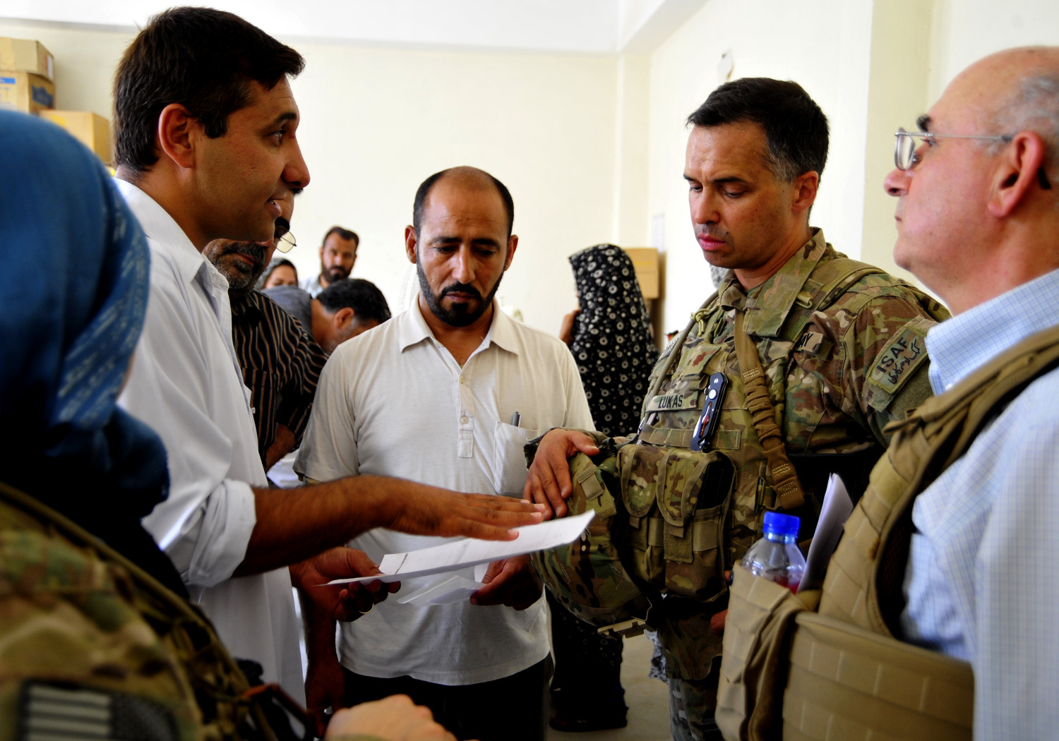 a group of men in military fatigues stand in a room