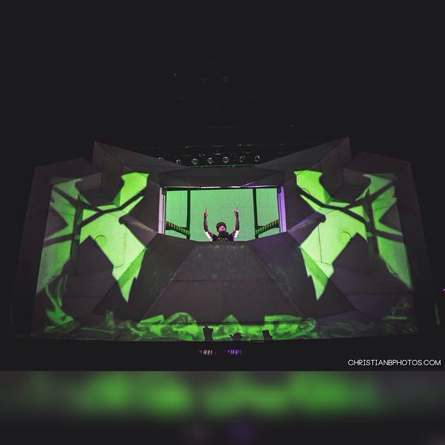 the stage at a concert is bathed with green lights