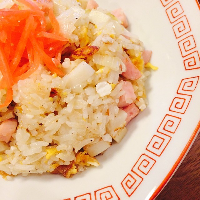 a white plate with rice, carrots, and meat on it