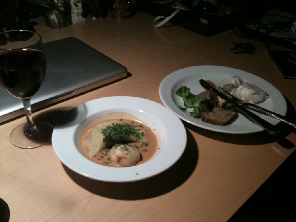 a table with two plates filled with soup and garnish