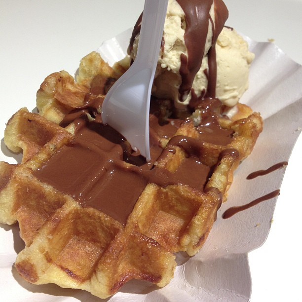 a spoon in a waffle with ice cream