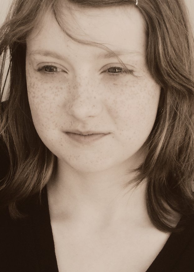 black and white pograph of young woman with freckles