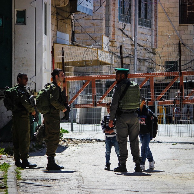 an image of a group of soldiers outside in a small town