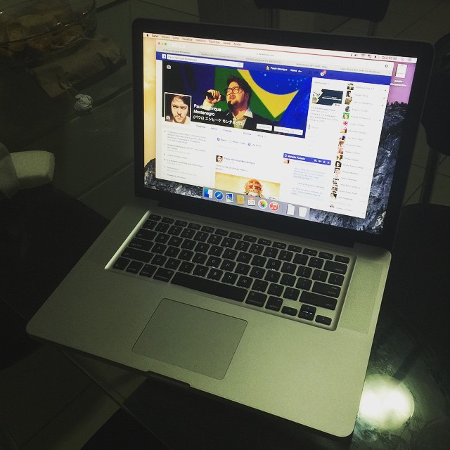 a laptop on a black table with yellow and green flags
