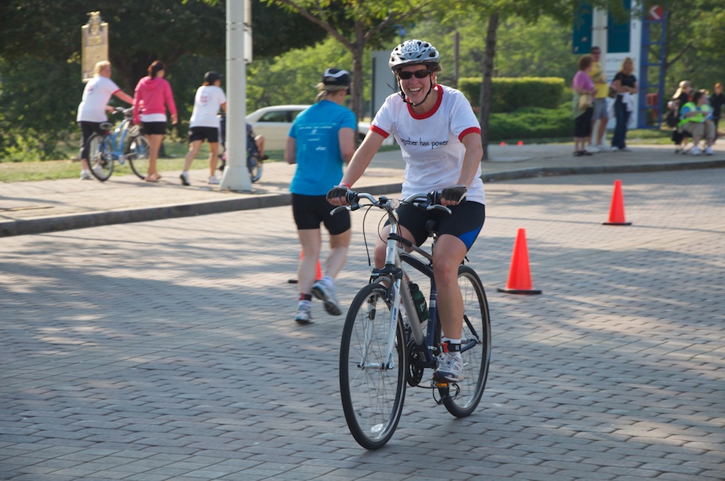 the cyclist has stopped at an orange traffic cone