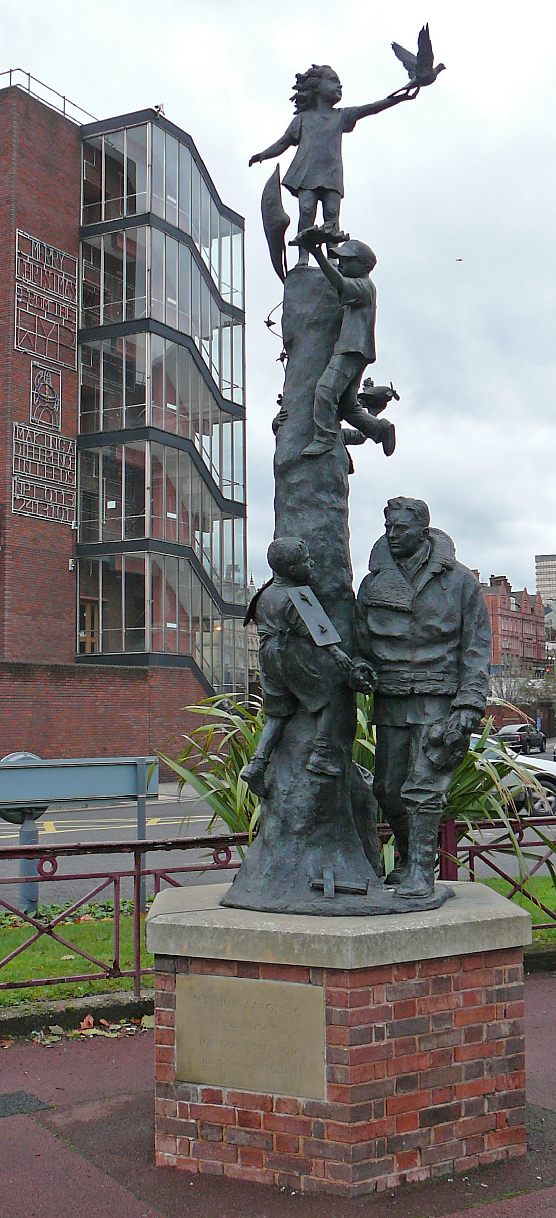 a sculpture with many people climbing it