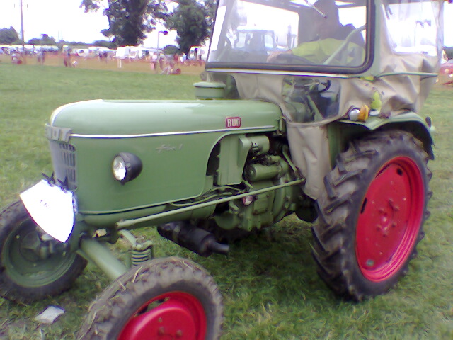 an old fashioned tractor in the middle of a field