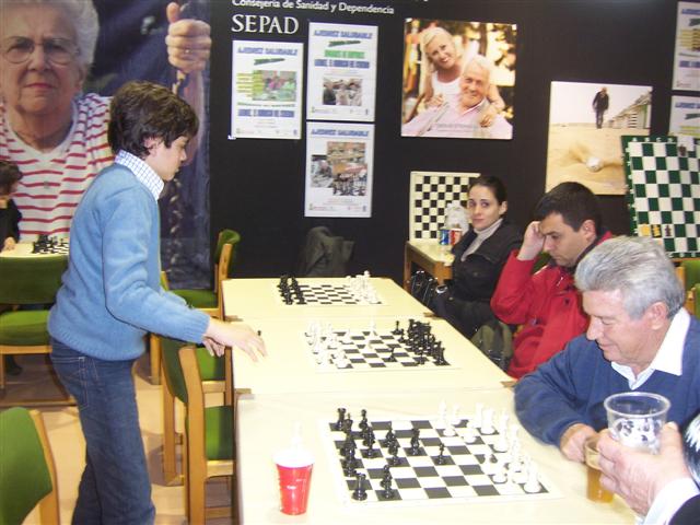 a person playing a game with chess while people sit around watching