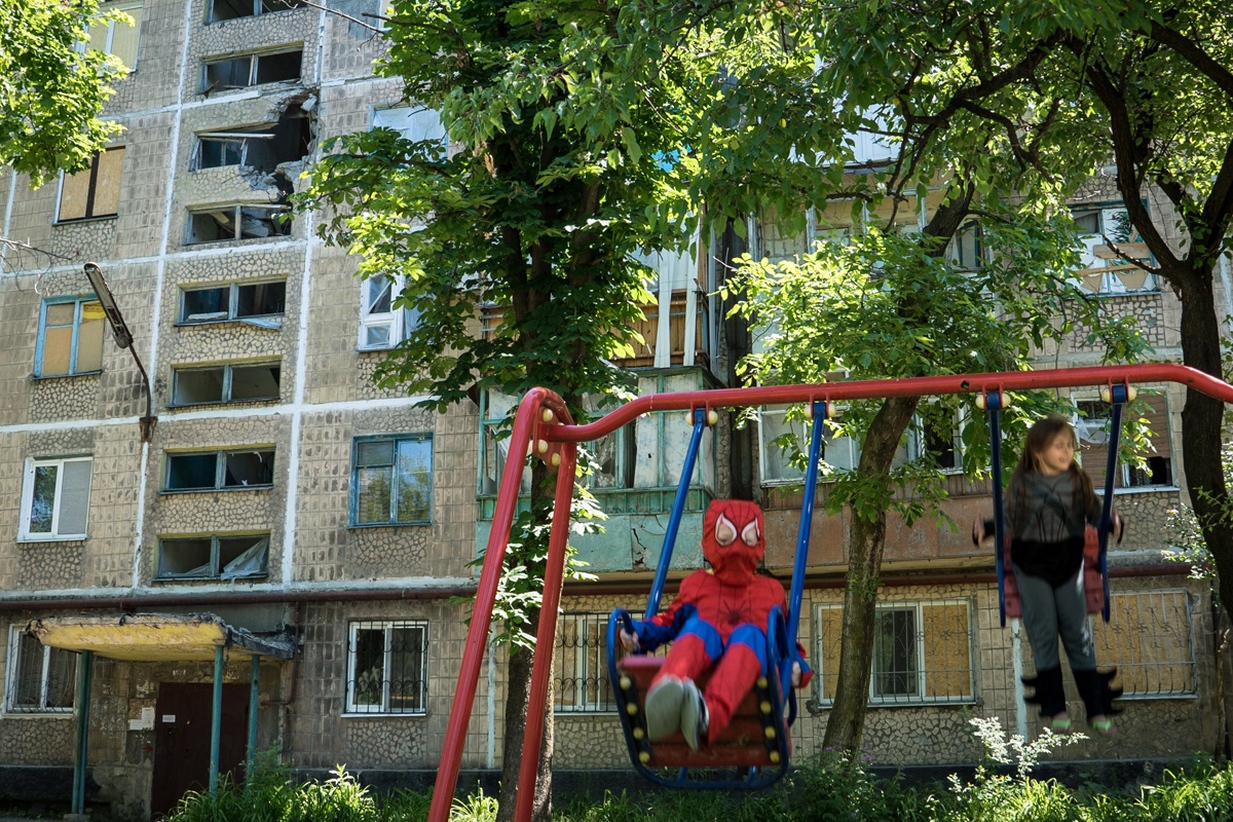 a young child swings on the swing set