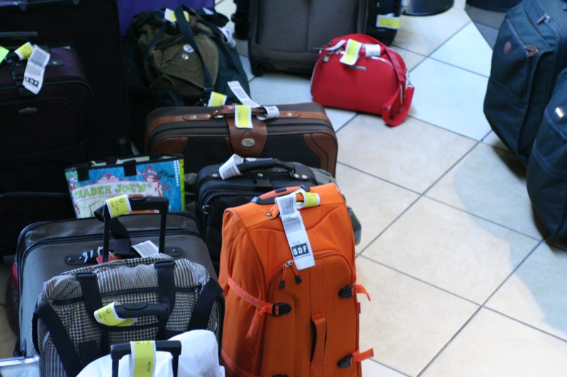 an assortment of suitcases lined up on the floor