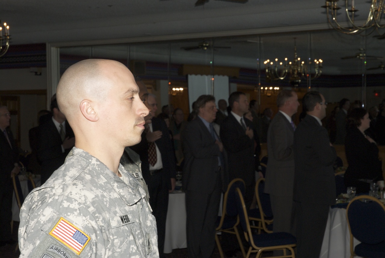 military man in uniform standing at a formal function